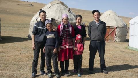 Kyrgyz family in front of a yurt near Song Kul lake Kyrgyz family in front of a yurt near Song Kul lake